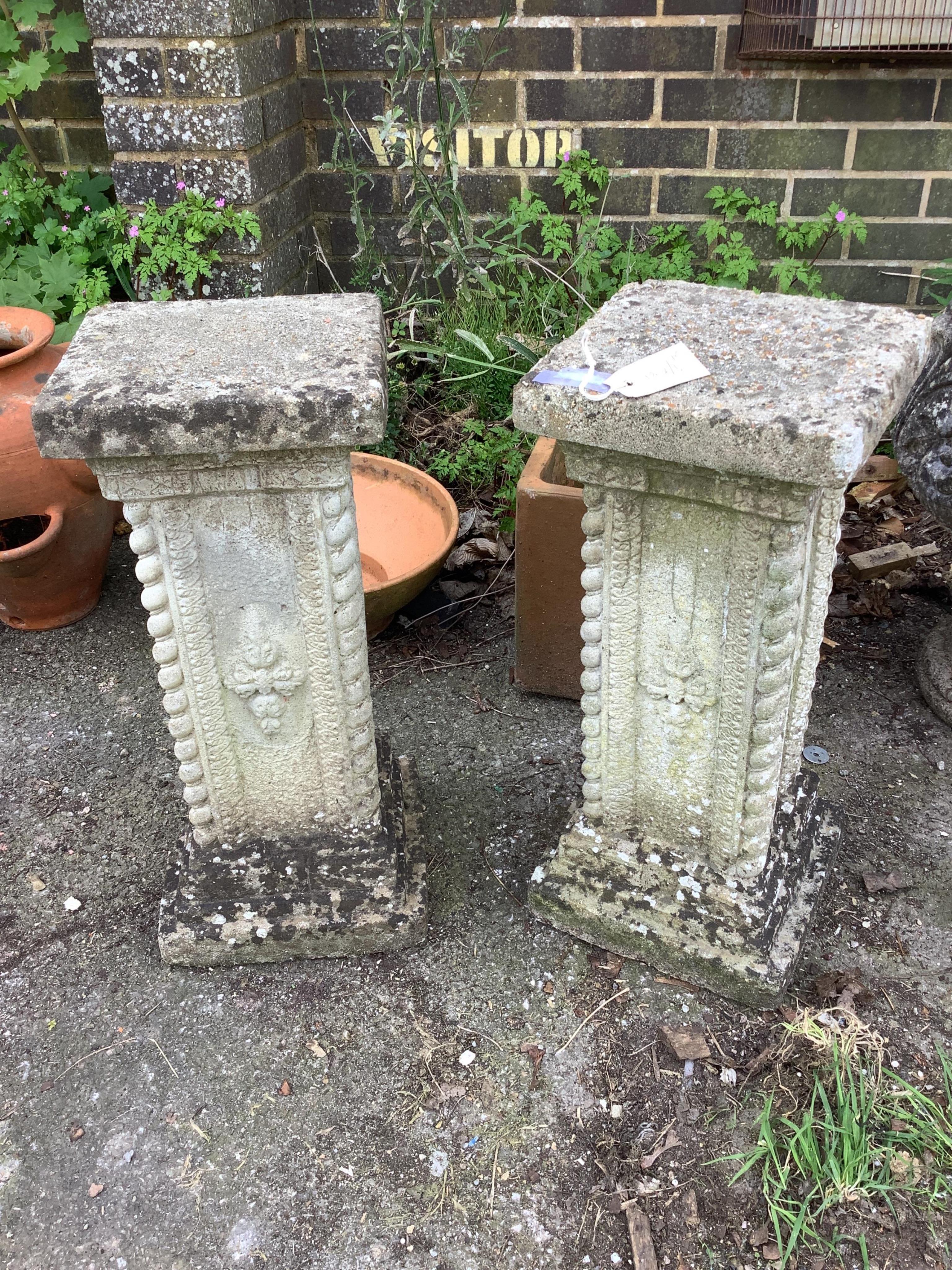 A pair of reconstituted stone garden pedestals, height 56cm
